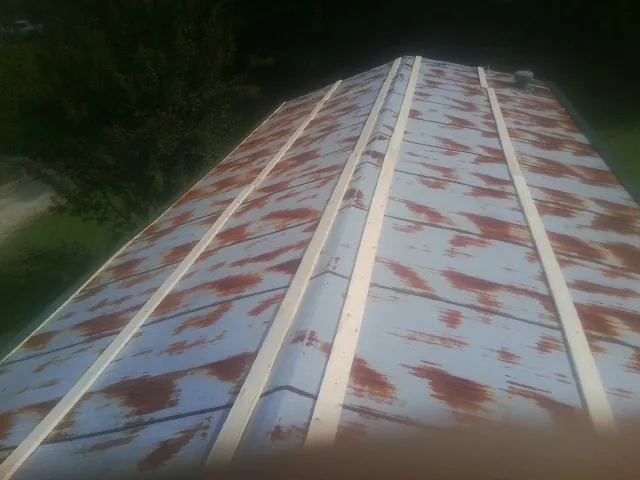 Rusted metal roof panels with new wood purlins before replacement — Storm Damage Roof Repair in Durkee by Roofing Brothers